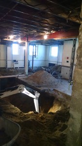 Towards the back, you can see where the bathrooms have been excavated. The big pile of stuff in the back right is old plumbing.