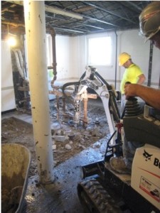 The bathroom floors being removed in order to install new plumbing.
