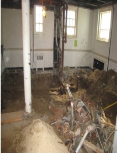 The bathrooms without a floor. You can see parts of the old plumbing which is being removed and replaced.