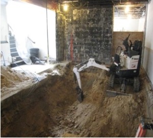 Lots of dirt is being removed from the floor in the "mezzanine" area near the former coat rack (which was on the black wall) to lower the floor to the Great Hall level in this area.